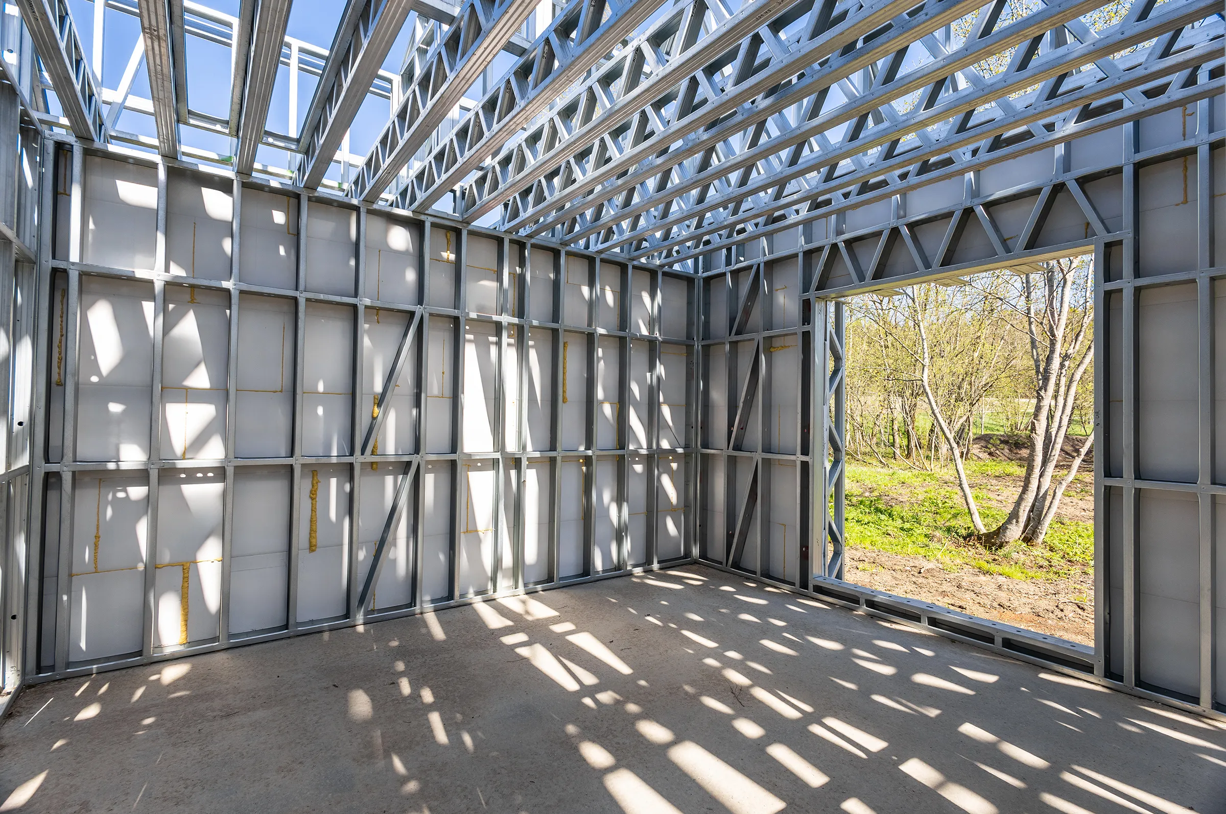 Interior of a steel-framed building shell with an open doorway